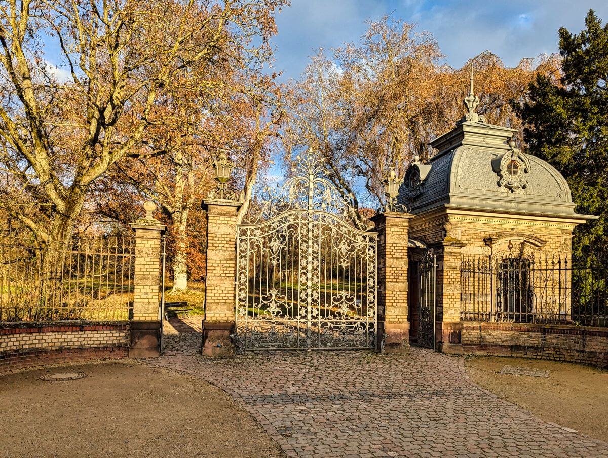 Historisches Pförtnerhaus auf der Rosenhöhe in Darmstadt, umgeben von Bäumen und Grünflächen.